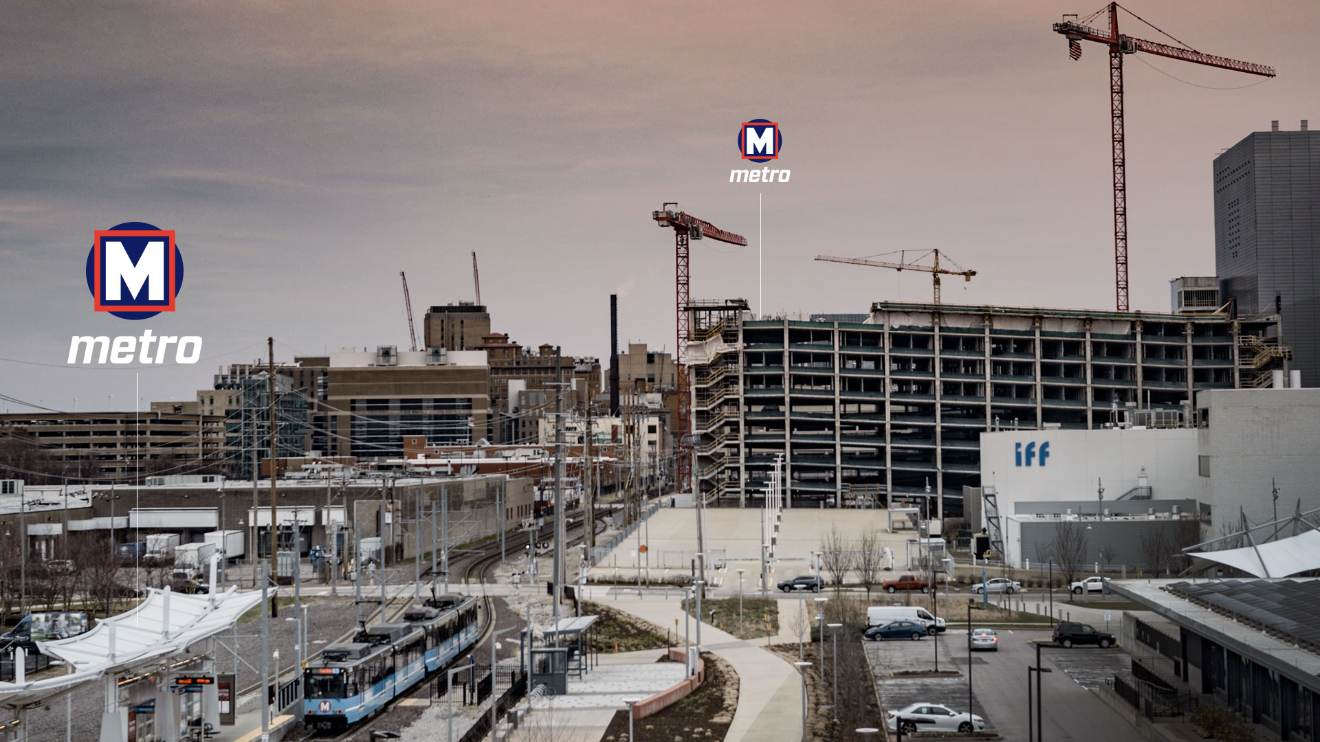 A photo of the Cortex area with a Metro station in the foreground and construction in the distance. Two Metro logos show the locations of each station.