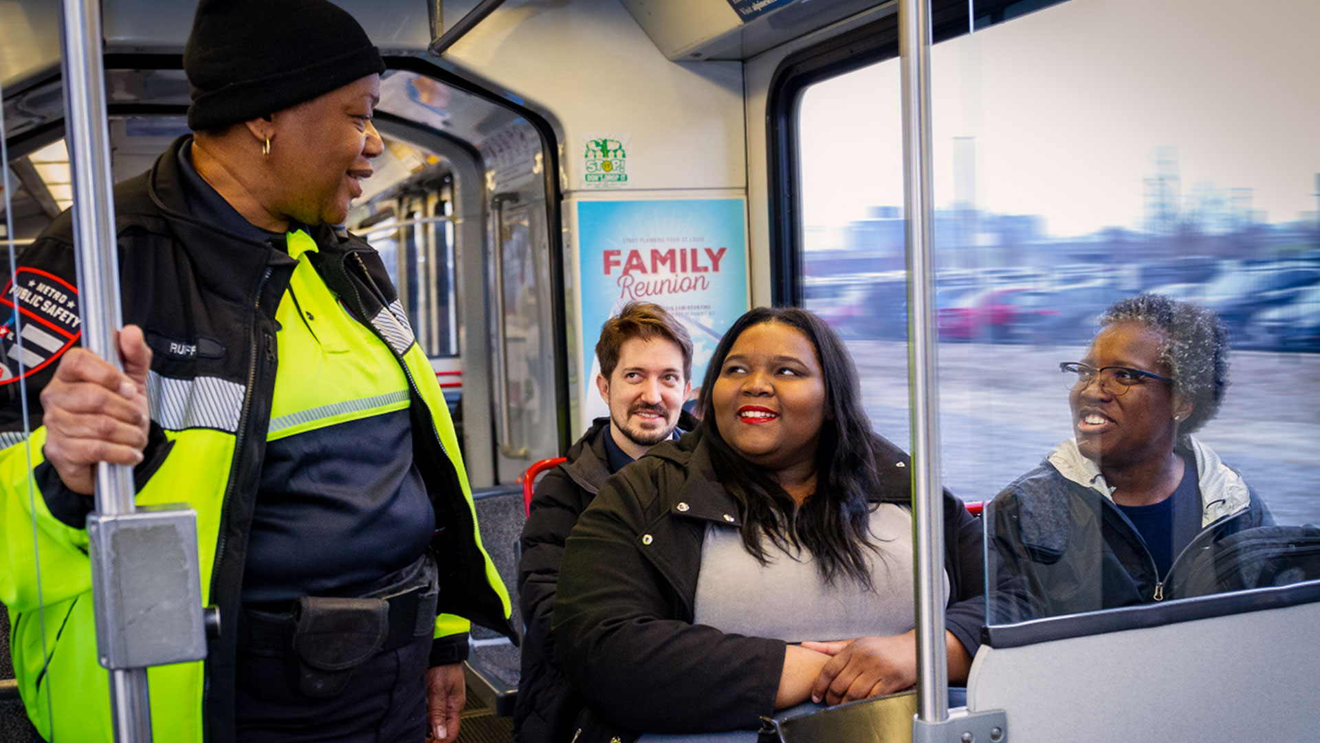 Metro security talks with passengers aboard MetroLink.