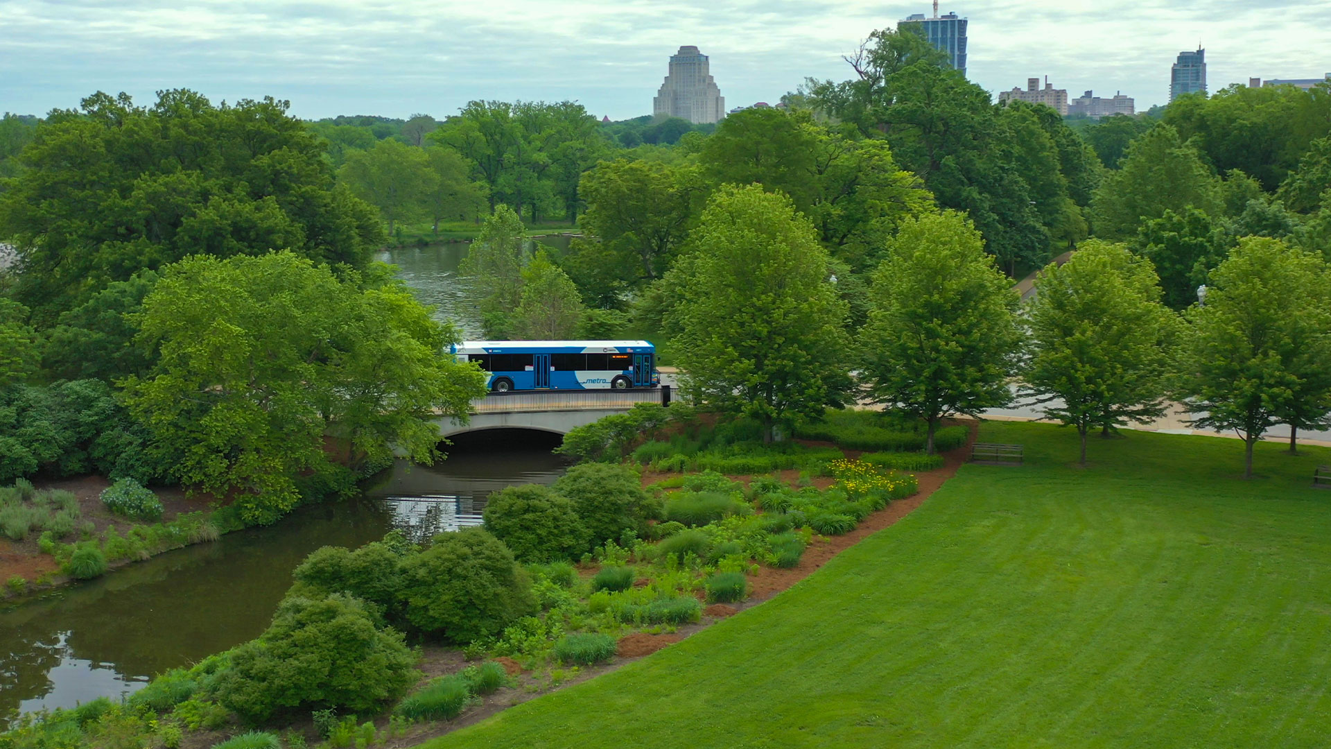 A Metro bus driving over a bridge in Forest Park.